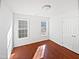 Bedroom featuring hardwood floors and two windows at 8209 Rolling Glenn Dr, Raleigh, NC 27616