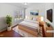 Staged bedroom with a comfortable bed and bright natural lighting at 8209 Rolling Glenn Dr, Raleigh, NC 27616
