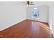 Spacious bonus room features hardwood floors, a ceiling fan, and natural light at 8209 Rolling Glenn Dr, Raleigh, NC 27616