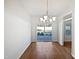 Bright dining room featuring hardwood floors, modern chandelier, and sliding doors to backyard at 8209 Rolling Glenn Dr, Raleigh, NC 27616