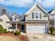 Charming two-story home features a stone facade and a two-car garage at 8209 Rolling Glenn Dr, Raleigh, NC 27616