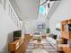 Bright living room with high ceilings, modern furnishings, and large windows at 8209 Rolling Glenn Dr, Raleigh, NC 27616