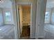 A bathroom featuring a tub and toilet is accessed between two carpeted rooms at 83 Commons Cir # 236, Clayton, NC 27520