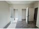 A bedroom shows two open closets with bars to hang clothing at 83 Commons Cir # 236, Clayton, NC 27520
