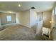 A bonus room with neutral walls and carpet is accessed from the stairwell and features a large window at 83 Commons Cir # 236, Clayton, NC 27520