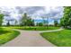 Walking paths in the community park on a sunny day, surrounded by green grass and trees at 83 Commons Cir # 236, Clayton, NC 27520