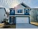 Charming two-story home with blue siding, a two-car garage, and manicured lawn at 83 Commons Cir # 236, Clayton, NC 27520