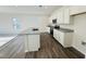 Modern kitchen boasts granite countertops, stainless steel appliances, and white cabinetry at 83 Commons Cir # 236, Clayton, NC 27520