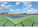 View of the community tennis courts surrounded by a green fence and net at 83 Commons Cir # 236, Clayton, NC 27520