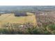 Aerial shot showcasing a vast land with fields, houses, and a forest at 8835 Us 64, Siler City, NC 27344
