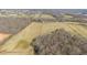 Aerial view showing fields with grazing cattle, trees, and rolling hills at 8835 Us 64, Siler City, NC 27344