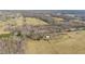 Aerial view of a countryside property featuring fields, trees, and outbuildings at 8835 Us 64, Siler City, NC 27344