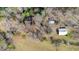 Aerial view of a house with outbuildings surrounded by trees at 8835 Us 64, Siler City, NC 27344