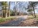 Driveway leading to a home surrounded by mature trees and lush foliage at 8835 Us 64, Siler City, NC 27344