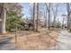 Home's exterior with a mailbox, mature trees, and lush foliage at 8835 Us 64, Siler City, NC 27344