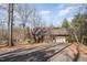 Garage on a lot with mature trees and a driveway with beautiful sunset skies at 8835 Us 64, Siler City, NC 27344