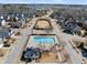 Aerial view of the community swimming pool with surrounding neighborhood and tree lined boulevards at 917 Sequoia Ridge Dr, Fuquay Varina, NC 27526