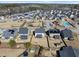 An aerial view of a neighborhood showcasing its layout, homes, and a community pool at 917 Sequoia Ridge Dr, Fuquay Varina, NC 27526