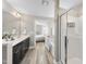 Bright bathroom featuring dual sinks, large mirror, tub, and glass-enclosed shower at 917 Sequoia Ridge Dr, Fuquay Varina, NC 27526