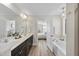 Bright bathroom boasting dual sinks, a large mirror, and an adjoining tub room at 917 Sequoia Ridge Dr, Fuquay Varina, NC 27526