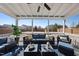 Spacious covered patio with outdoor seating, ceiling fan, and clear backyard views at 917 Sequoia Ridge Dr, Fuquay Varina, NC 27526
