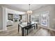Dining room with a view to the living room, fireplace, and a glass door with exterior view at 917 Sequoia Ridge Dr, Fuquay Varina, NC 27526
