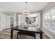 Dining room with a chandelier, dark wood table, and a view to the living room and fireplace at 917 Sequoia Ridge Dr, Fuquay Varina, NC 27526