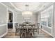 Elegant dining area with a modern chandelier and natural light from the window at 917 Sequoia Ridge Dr, Fuquay Varina, NC 27526