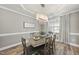 Elegant dining area with a modern chandelier and natural light from the window at 917 Sequoia Ridge Dr, Fuquay Varina, NC 27526