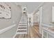 Bright foyer with staircase and wood flooring, leading to open living spaces at 917 Sequoia Ridge Dr, Fuquay Varina, NC 27526