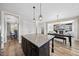 Open kitchen with island, granite countertops, and a view of the living room with fireplace at 917 Sequoia Ridge Dr, Fuquay Varina, NC 27526