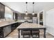 Modern kitchen with granite countertops, stainless steel appliances, and dark wood cabinets at 917 Sequoia Ridge Dr, Fuquay Varina, NC 27526