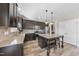 Modern kitchen with granite countertops, stainless steel appliances, and dark wood cabinets at 917 Sequoia Ridge Dr, Fuquay Varina, NC 27526