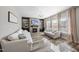 Bright living room with a fireplace, built-in cabinets, and large windows with natural light at 917 Sequoia Ridge Dr, Fuquay Varina, NC 27526