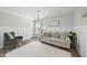 Cozy living room features wainscoting, hardwood floors, a chandelier, and a plush white rug at 917 Sequoia Ridge Dr, Fuquay Varina, NC 27526