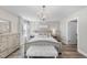 Bright bedroom featuring a decorative chandelier, neutral colors, and a cozy seating bench at 917 Sequoia Ridge Dr, Fuquay Varina, NC 27526