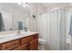 Well-maintained bathroom with a vanity, framed mirror and shower with blue decorative shower curtain at 1003 Branwell Dr, Durham, NC 27703
