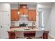 Well-equipped kitchen featuring stainless steel appliances, granite countertops, and an island with chairs at 1003 Branwell Dr, Durham, NC 27703