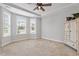 Well-lit main bedroom featuring large windows, and plush carpet at 1003 Branwell Dr, Durham, NC 27703