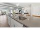 Open concept kitchen with a large island featuring a stainless steel sink, pendant lighting, and hardwood floors at 1237 S Blount Street # 201, Raleigh, NC 27601