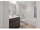 Bathroom featuring single vanity with dark wood cabinet and shower-tub combination at 124 Currituck Ln, Durham, NC 27703