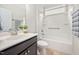 Bathroom featuring single vanity with dark wood cabinet and shower-tub combination with safety bar at 124 Currituck Ln, Durham, NC 27703
