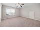 Bedroom featuring neutral carpet, ceiling fan, and window letting in natural light at 124 Currituck Ln, Durham, NC 27703