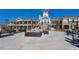 Exterior shot of a community clubhouse with patio seating and landscaped grounds at 124 Currituck Ln, Durham, NC 27703
