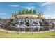 Landscaped community entrance sign with a waterfall feature under a clear sky at 124 Currituck Ln, Durham, NC 27703