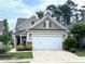 Charming home featuring a two-car garage and well-manicured landscaping at 124 Currituck Ln, Durham, NC 27703