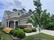 Inviting home with a covered porch and lush, colorful landscaping at 124 Currituck Ln, Durham, NC 27703