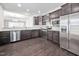 Modern kitchen with stainless steel appliances and dark wood cabinets at 124 Currituck Ln, Durham, NC 27703