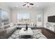 Bright living room featuring a comfortable gray sofa, modern rug, and natural light from large windows at 124 Currituck Ln, Durham, NC 27703
