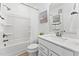 Bright bathroom features a shower-tub combo, neutral-toned tile and a white vanity with modern fixtures at 1247 Shaw View Alley # 101, Raleigh, NC 27601